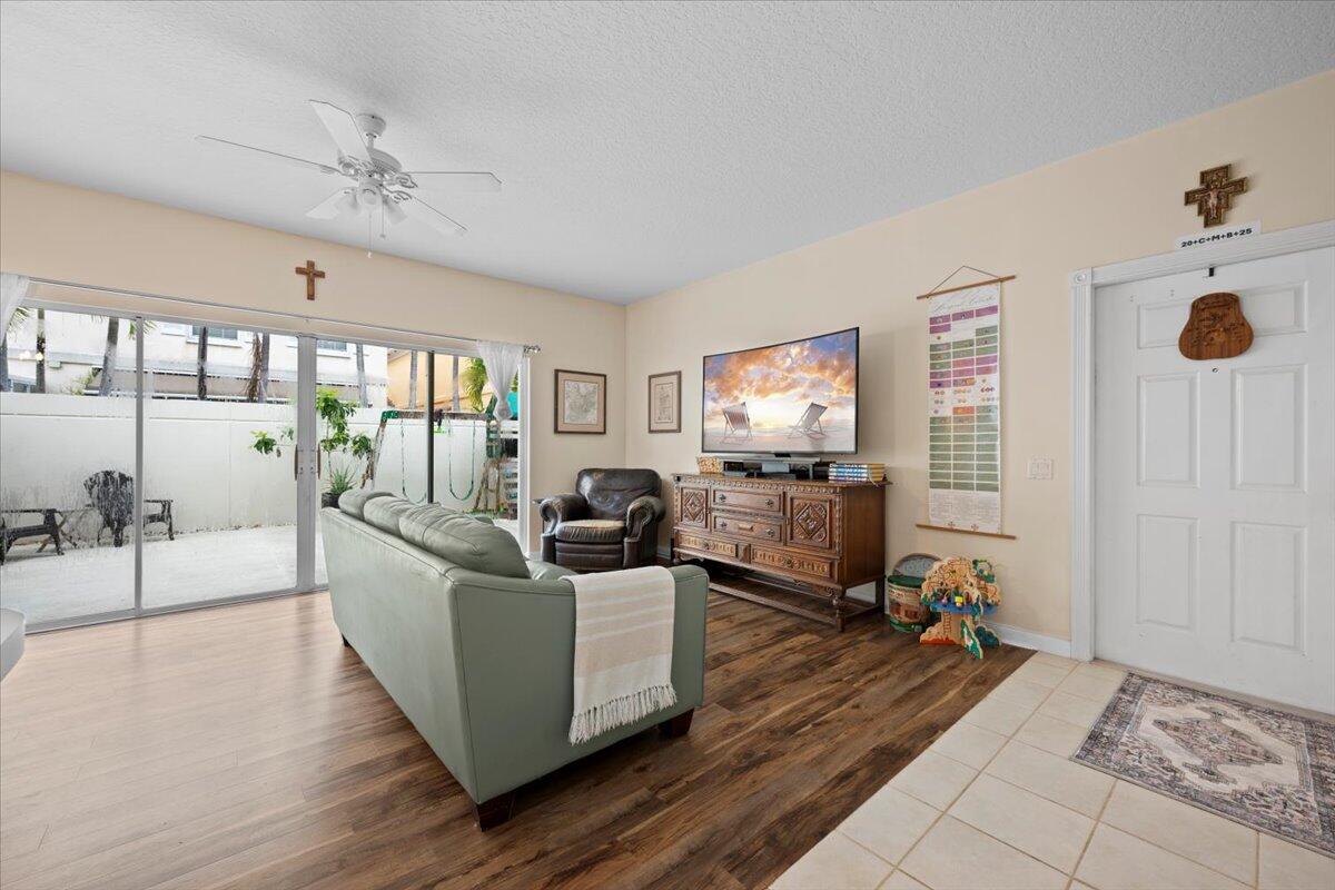 11 Live Oak Circle, Unit 11 Tequesta, FL 33469 - Photo 10 of 27 a living room with furniture and a flat screen tv