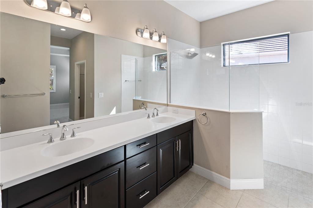 13017 Steinhatchee Loop Venice, FL 34293 - Photo 29 of 98 a bathroom with a double vanity sink and a mirror