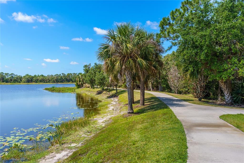 13017 Steinhatchee Loop Venice, FL 34293 - Photo 97 of 98 a view of a lake with a yard