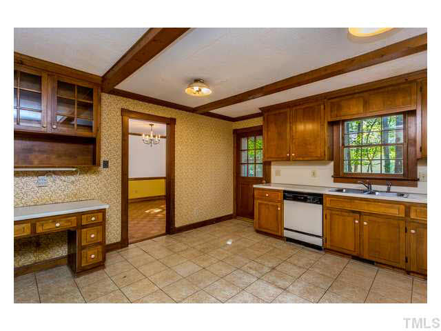 8205 Holly Berry Court Raleigh, NC 27615 - Photo 11 of 24 a kitchen with stainless steel appliances granite countertop a sink and a stove
