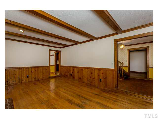 8205 Holly Berry Court Raleigh, NC 27615 - Photo 7 of 24 a view of an empty room with wooden floor