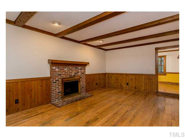 8205 Holly Berry Court Raleigh, NC 27615 - Photo 8 of 24 a view of an empty room and wooden floor