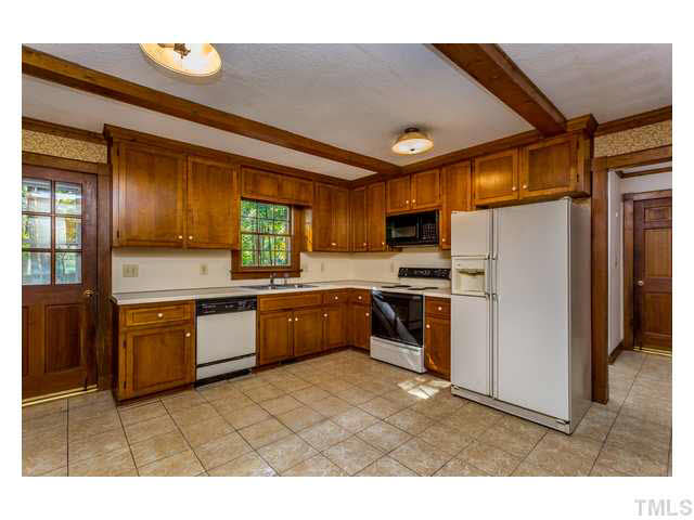 8205 Holly Berry Court Raleigh, NC 27615 - Photo 10 of 24 a kitchen with stainless steel appliances granite countertop a refrigerator a sink dishwasher a stove with wooden cabinets