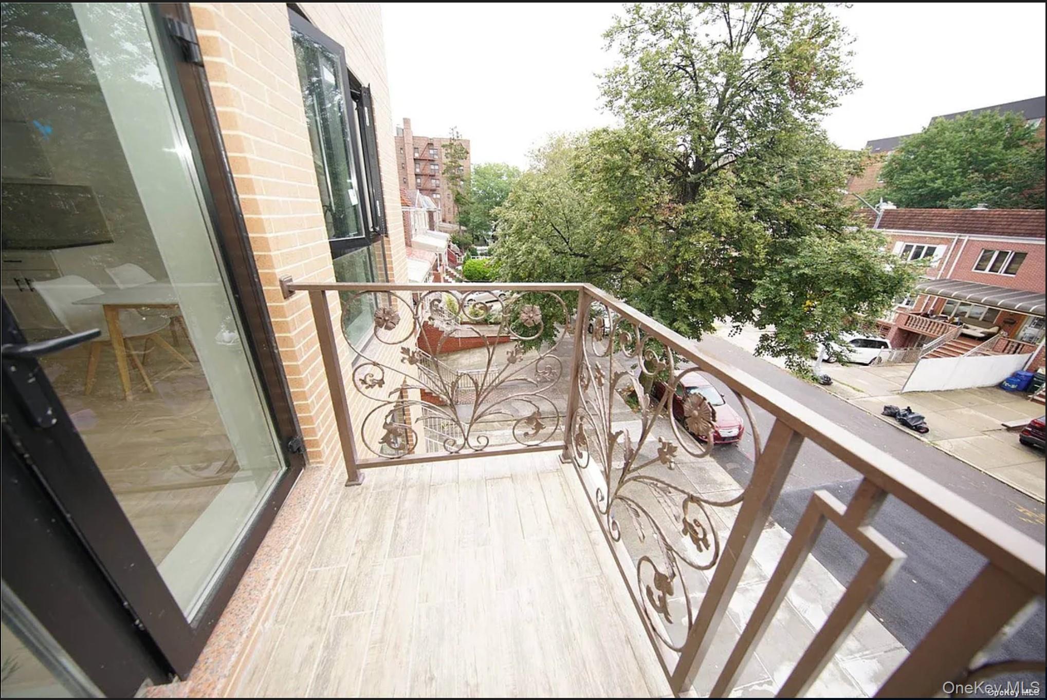a view of a balcony with wooden floor and fence