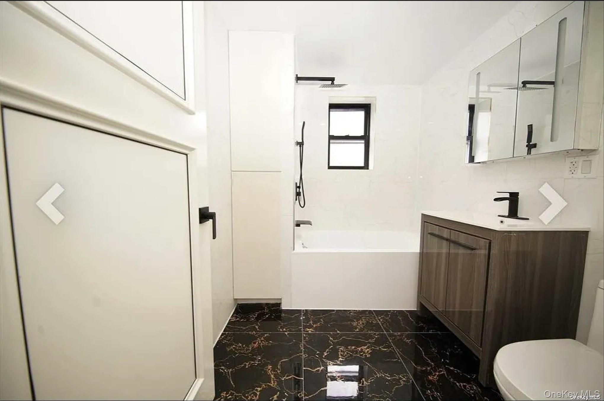 105-25 65th Road, Unit 5C Queens, NY 11375 - Photo 2 of 8 a bathroom with a sink toilet and shower