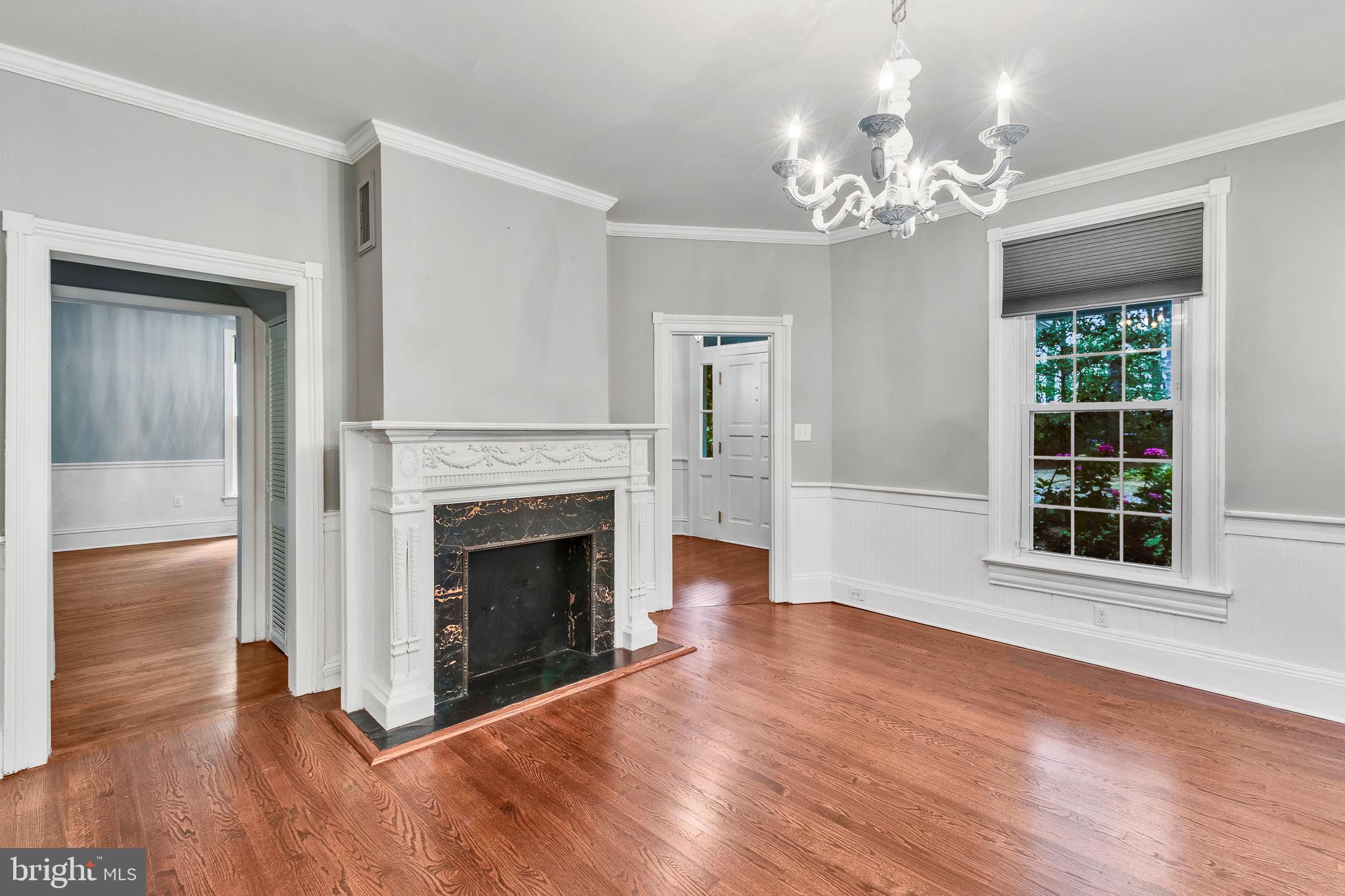 3952 Irvington Road Irvington, VA 22480 - Photo 8 of 77 a view of an empty room with wooden floor and a fireplace