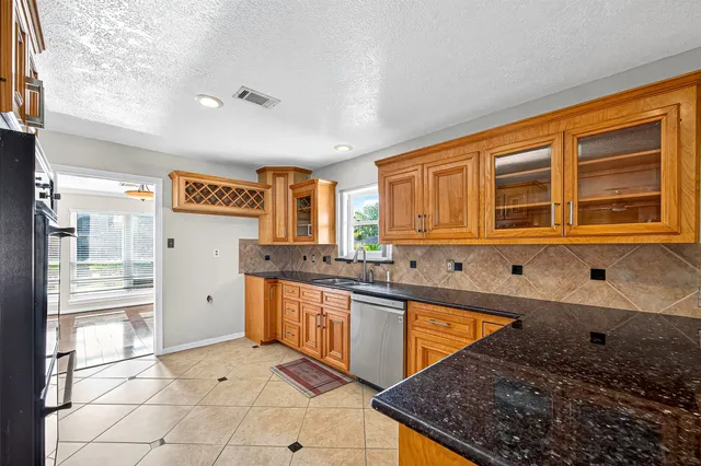 a kitchen with stainless steel appliances granite countertop a stove and a sink