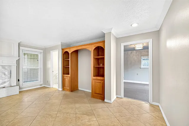 an empty room with closet and windows