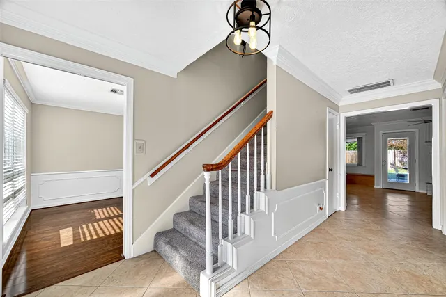 a view of entryway and hall with wooden floor