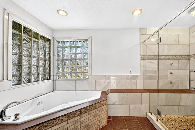 a bathroom with a tub and a shower