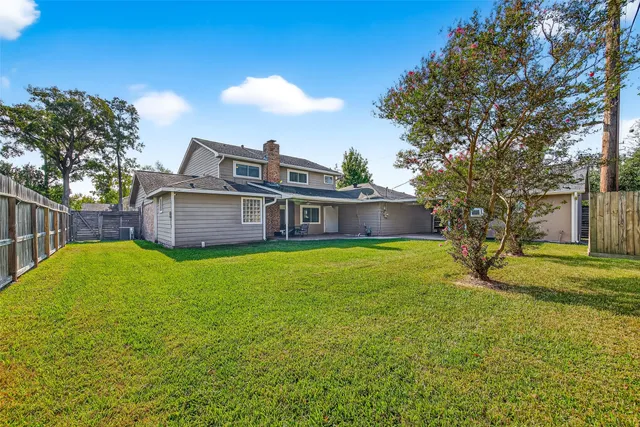 a view of a house with a backyard