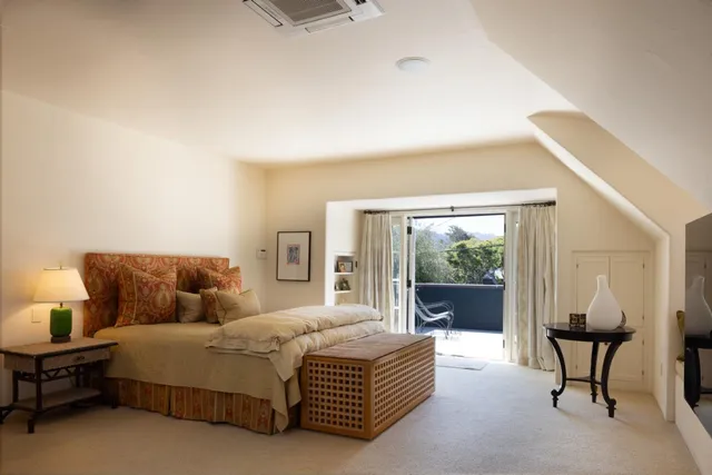 a bedroom with a large bed and a window