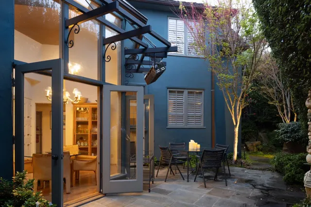 a view of a brick house with large windows and table