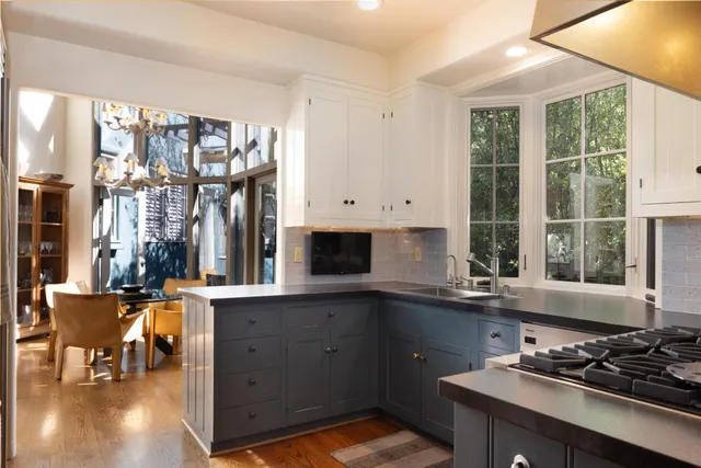 a kitchen with a sink stove and cabinets