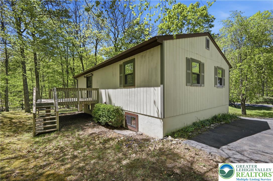 505 Chipmunk Road Bushkill, PA 18324 - Photo 30 of 46 a front view of a house with garden