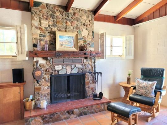 1549 South Gordon Street Ridgecrest, CA 93555 - Photo 24 of 44 a living room with furniture a fireplace and a flat screen tv