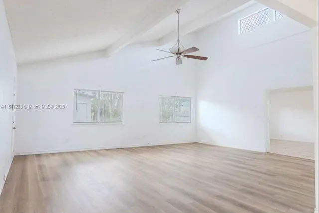 a view of room with hardwood floor and ceiling fan