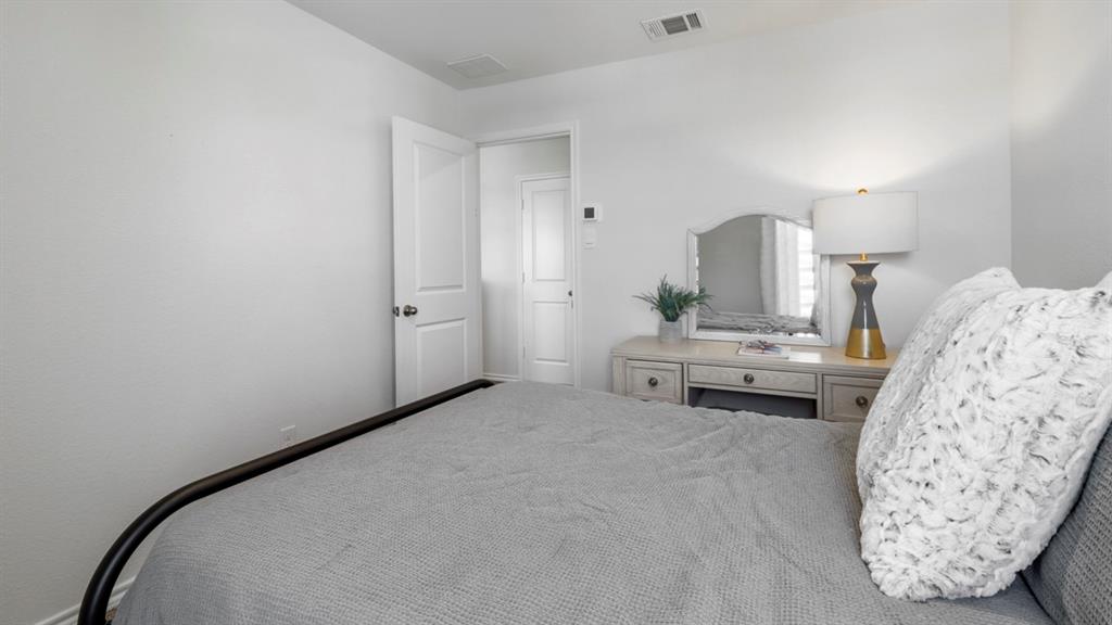 636 Dunham Road Nevada, TX 75173 - Photo 5 of 31 Neutral-toned bedroom featuring white walls and a white interior door
