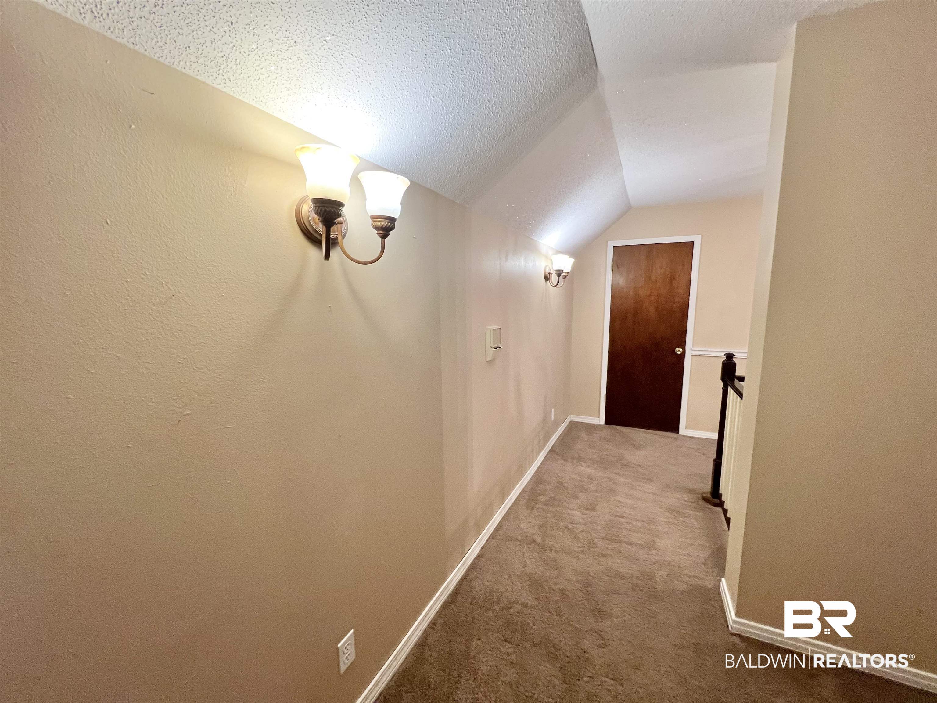 2691 Appleton Road Brewton, AL 36426 - Photo 32 of 60 Hallway featuring a textured ceiling, vaulted ceiling, and carpet flooring