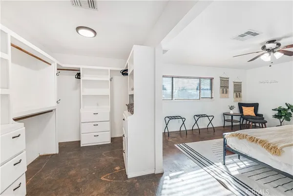 a bedroom with furniture and a dresser