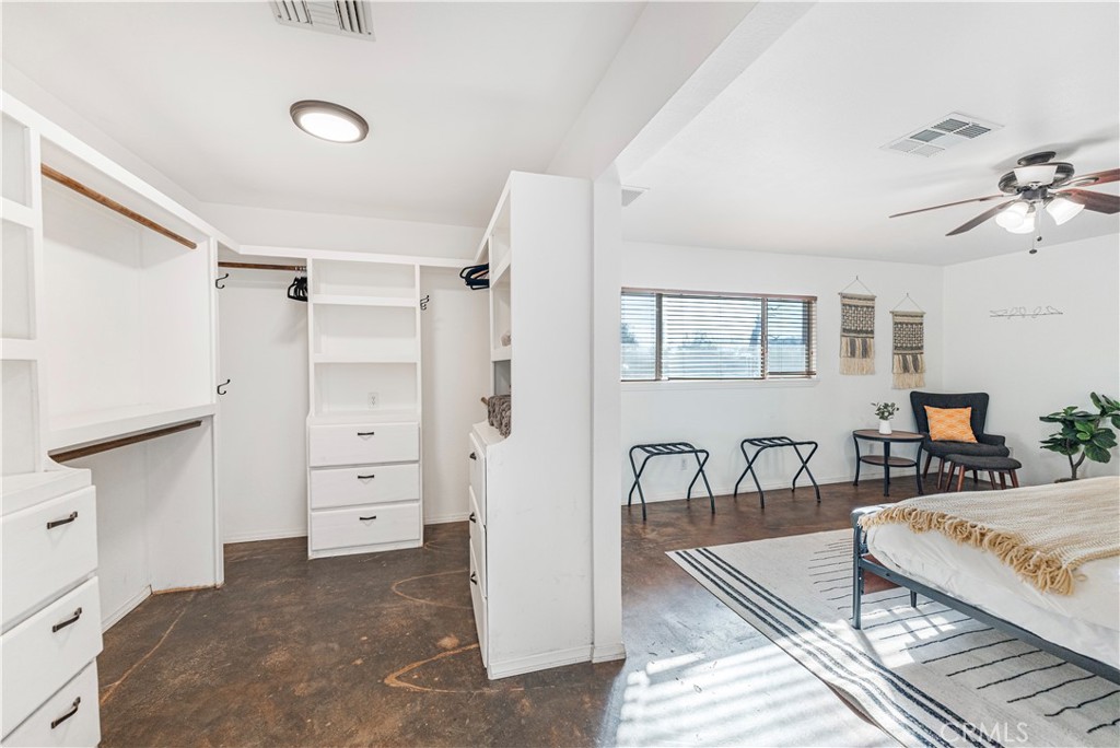 7071 Rubidoux Avenue Yucca Valley, CA 92284 - Photo 12 of 50 a bedroom with furniture and a dresser