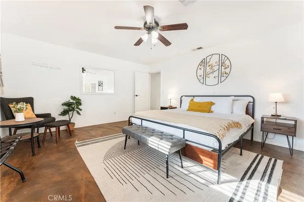 a spacious bedroom with a bed and a table in it