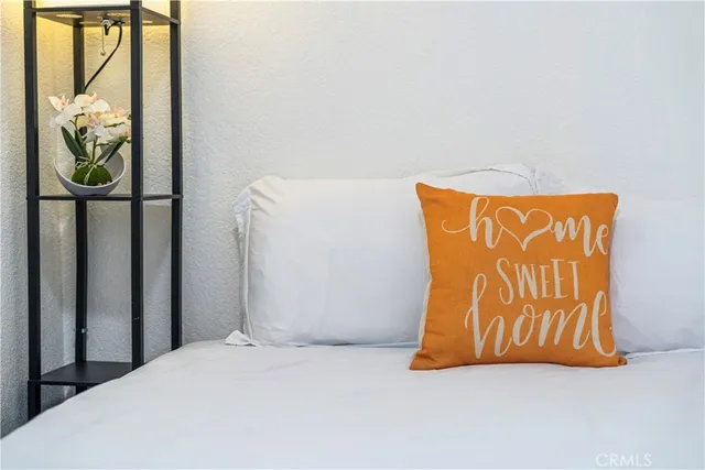 a bedroom with a bed and a painting on the wall