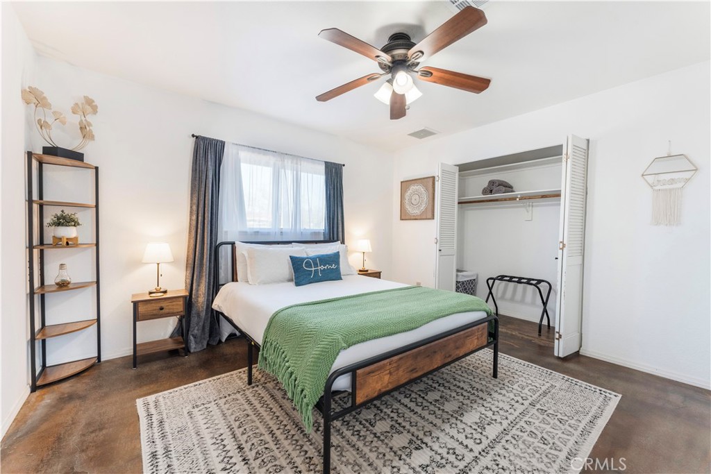 7071 Rubidoux Avenue Yucca Valley, CA 92284 - Photo 20 of 50 a bedroom with a bed and a chandelier