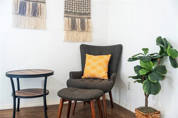 a living room with furniture and a potted plant