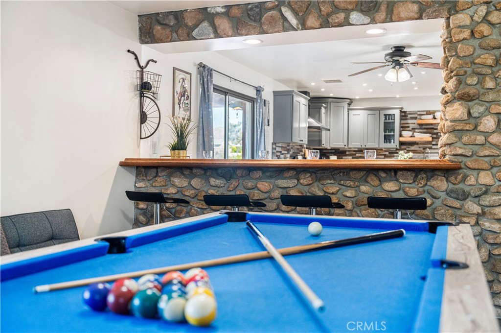 7071 Rubidoux Avenue Yucca Valley, CA 92284 - Photo 30 of 50 a kitchen with stainless steel appliances a sink and cabinets