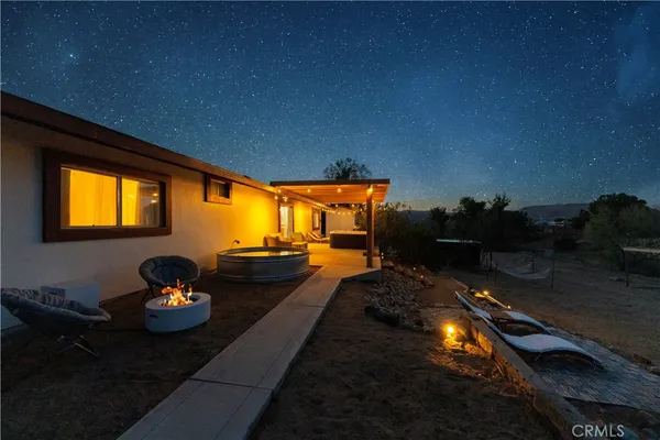 a night view of a couch in front of a house