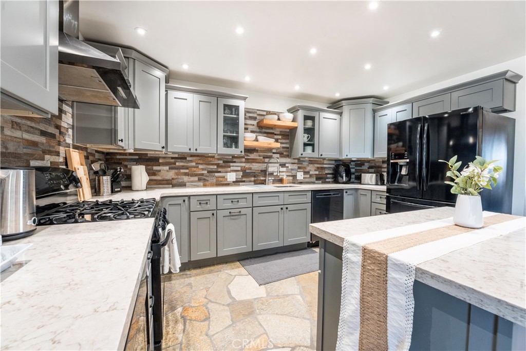 7071 Rubidoux Avenue Yucca Valley, CA 92284 - Photo 32 of 50 a kitchen with a sink a stove and cabinets