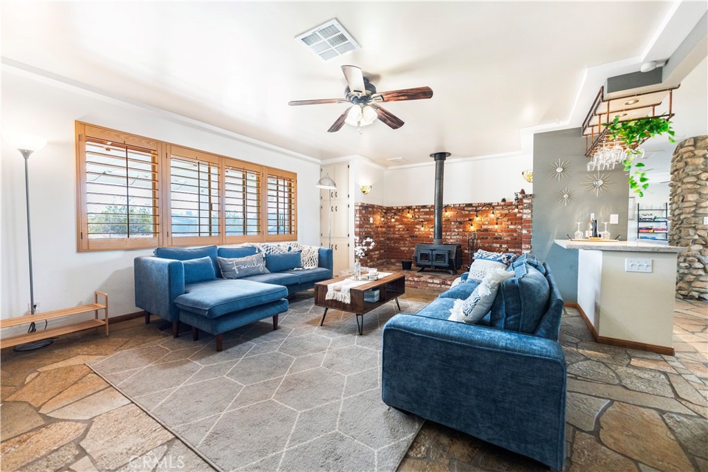 7071 Rubidoux Avenue Yucca Valley, CA 92284 - Photo 34 of 50 a living room with furniture and a large window