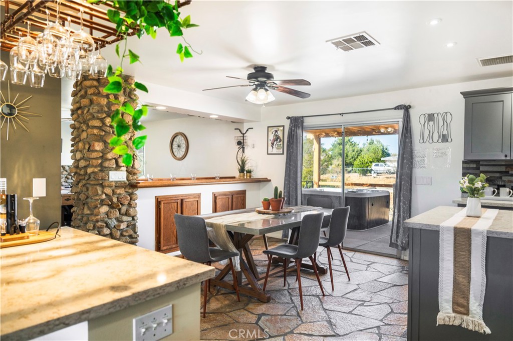 7071 Rubidoux Avenue Yucca Valley, CA 92284 - Photo 39 of 50 a view of a dining room with furniture and a chandelier