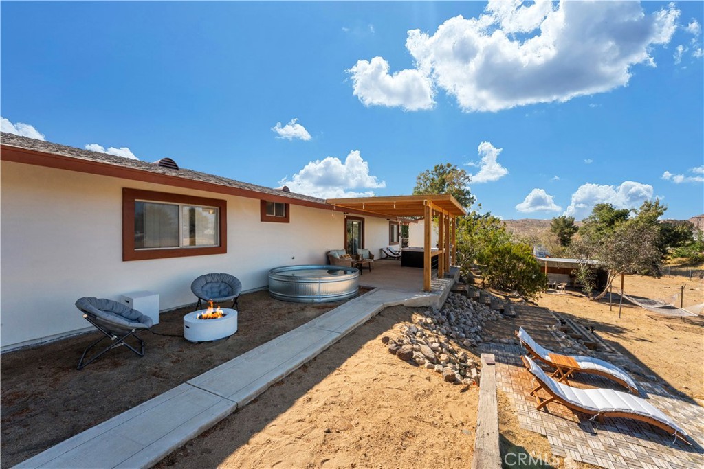 7071 Rubidoux Avenue Yucca Valley, CA 92284 - Photo 42 of 50 a living room with furniture and a chandelier
