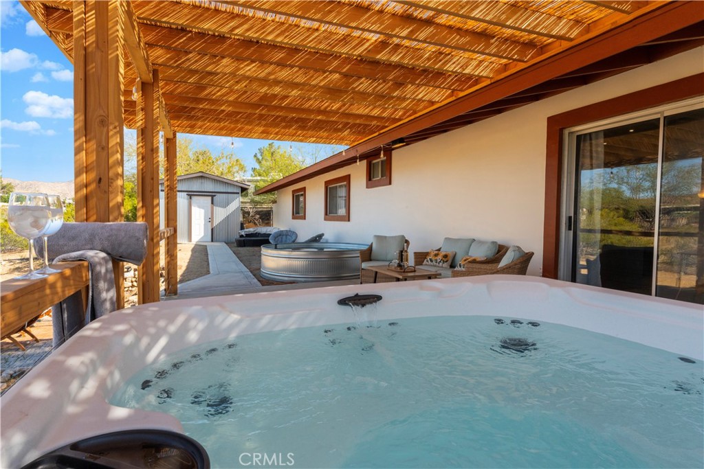 7071 Rubidoux Avenue Yucca Valley, CA 92284 - Photo 46 of 50 a backyard of a house with table and chairs