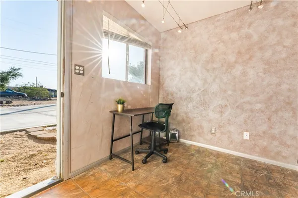 a view of a room with a table and chairs