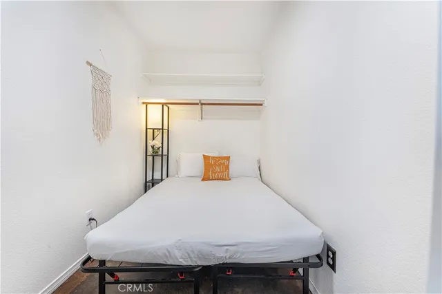 a bed sitting in a bedroom next to a window