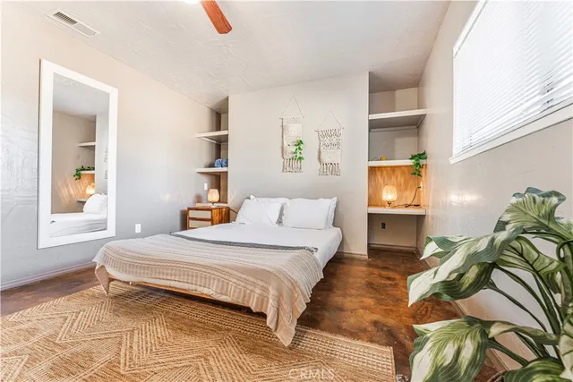 a bedroom with a bed and a window