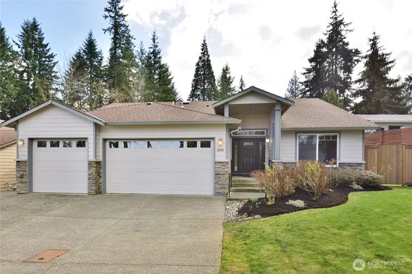 a front view of a house with a yard and garage