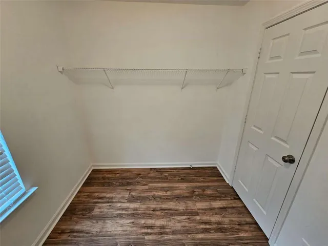 a view of a room with wooden floor and staircase