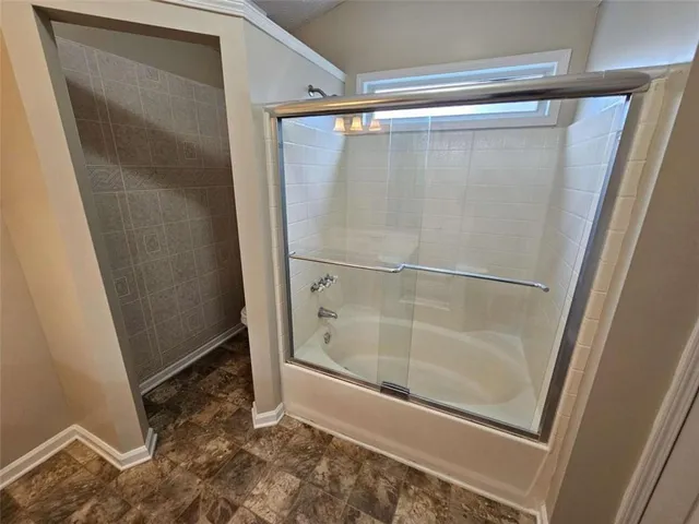 a bathroom with a glass shower door