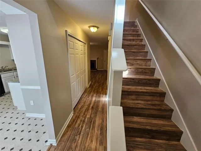 a view of entryway and hall with wooden floor