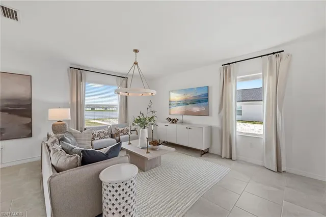 a living room with furniture and a chandelier
