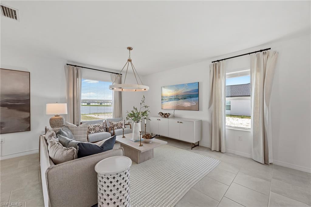 a living room with furniture and a chandelier