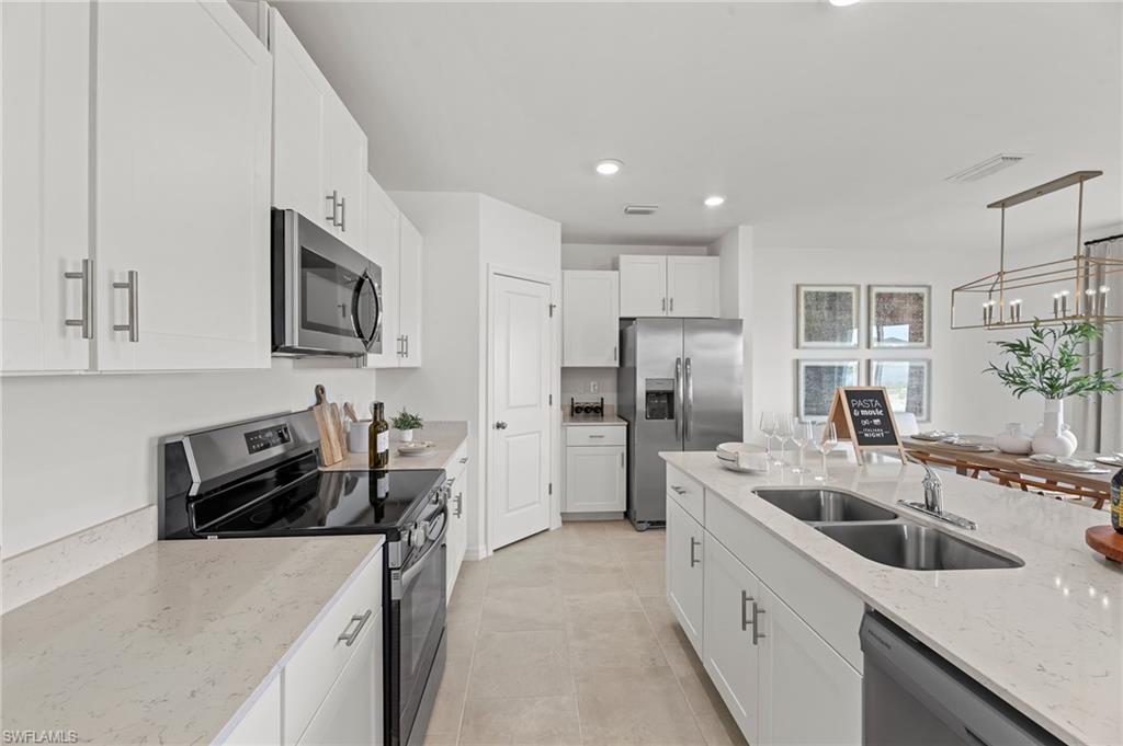 17251 Monte Isola Way North Fort Myers, FL 33917 - Photo 14 of 39 a kitchen that has a sink cabinets counter space and stainless steel appliances