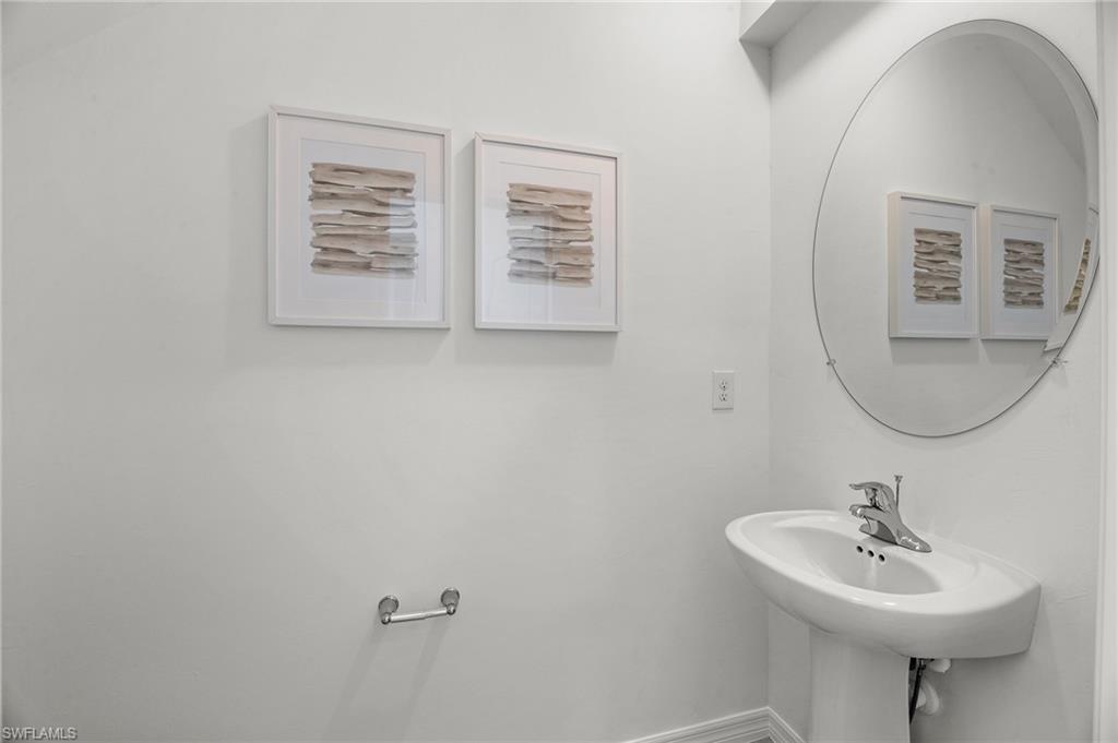 17251 Monte Isola Way North Fort Myers, FL 33917 - Photo 17 of 39 a bathroom with a sink a mirror and vanity