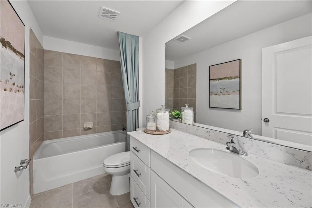 17251 Monte Isola Way North Fort Myers, FL 33917 - Photo 22 of 39 a bathroom with a granite countertop sink a toilet and shower