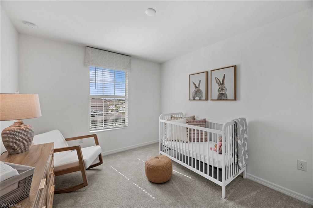17251 Monte Isola Way North Fort Myers, FL 33917 - Photo 23 of 39 a bedroom with furniture and a window
