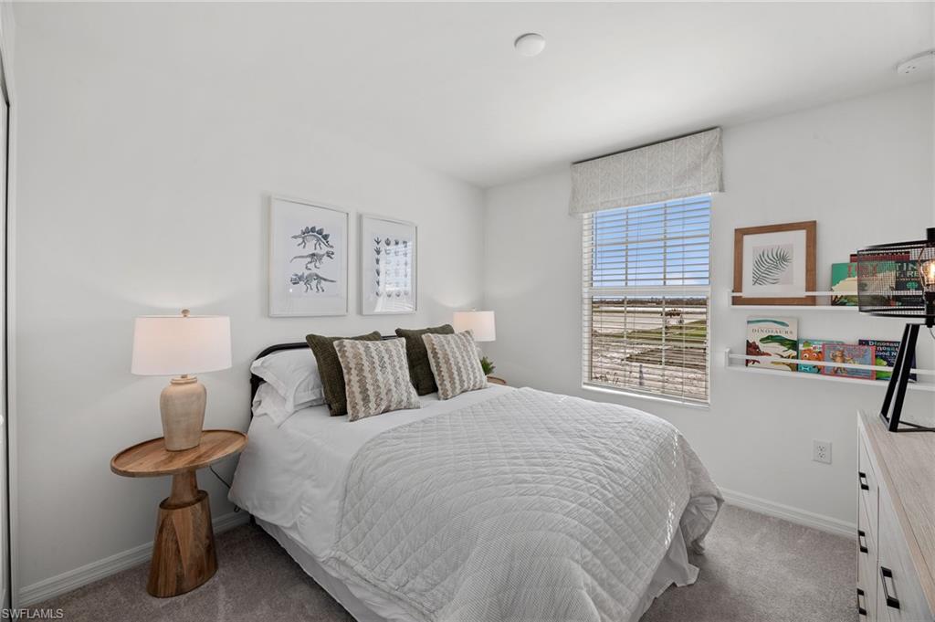 17251 Monte Isola Way North Fort Myers, FL 33917 - Photo 25 of 39 a bed room with a bed and a table